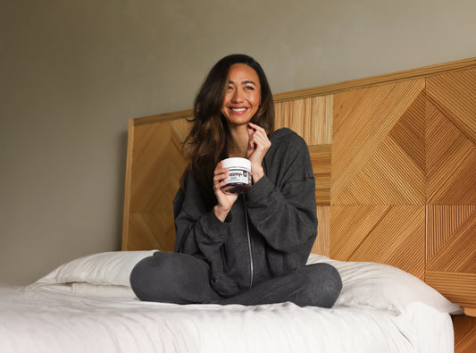 Sleep - Reishi and Melatonin - Black Raspberry - Sleep Support - Woman in Pajamas Holding Gummy - Troomy Nootropics in Whittier, CA
