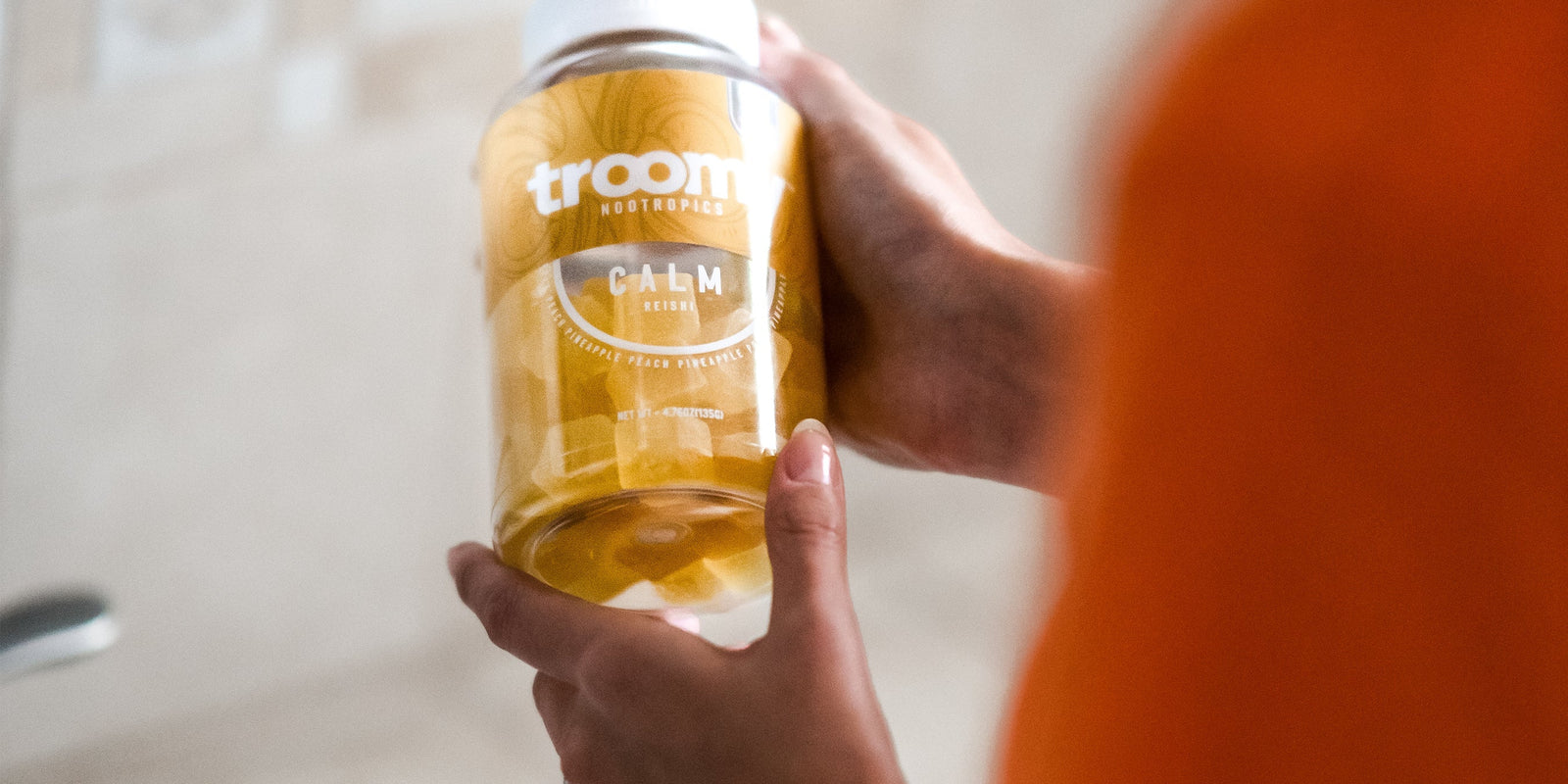 Calm - Reishi - Pineapple Peach - Zen Moment - Woman Holding Jar - Troomy Nootropics in Whittier, CA