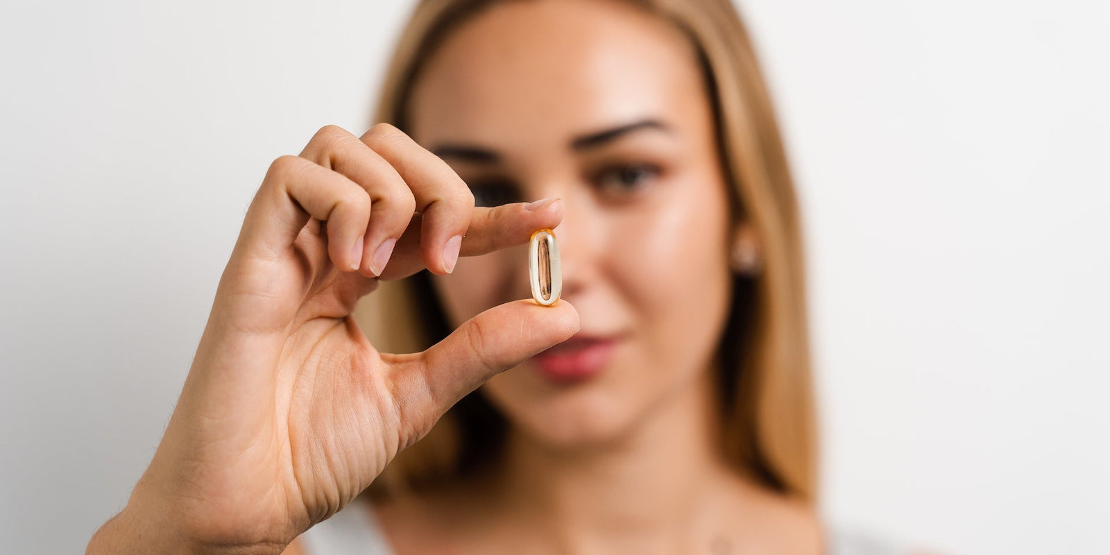 Shine - Tremella and Biotin - White Peach Pomegranate - Beauty Support - Woman Holding Capsule- Troomy Nootropics in Whittier, CA