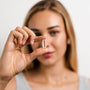 Shine - Tremella and Biotin - White Peach Pomegranate - Beauty Support - Woman Holding Capsule- Troomy Nootropics in Whittier, CA
