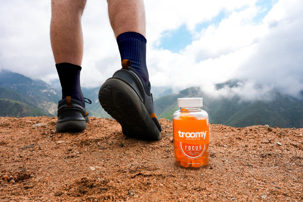 Hiking Habits - Focus Lion’s Mane Gummies - Tangerine Passionfruit  - Brain Support - Standing Next to60ct Jar - Troomy Nootropics in Whittier, CA