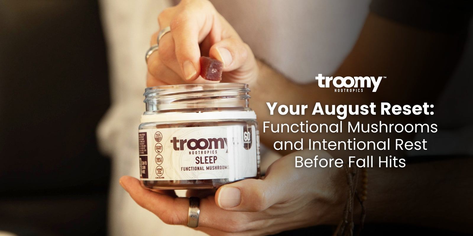 man reaching into a jar of purple sleep gummies