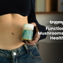 woman holding glp1 capsules weight loss management pills next to toned stomach
