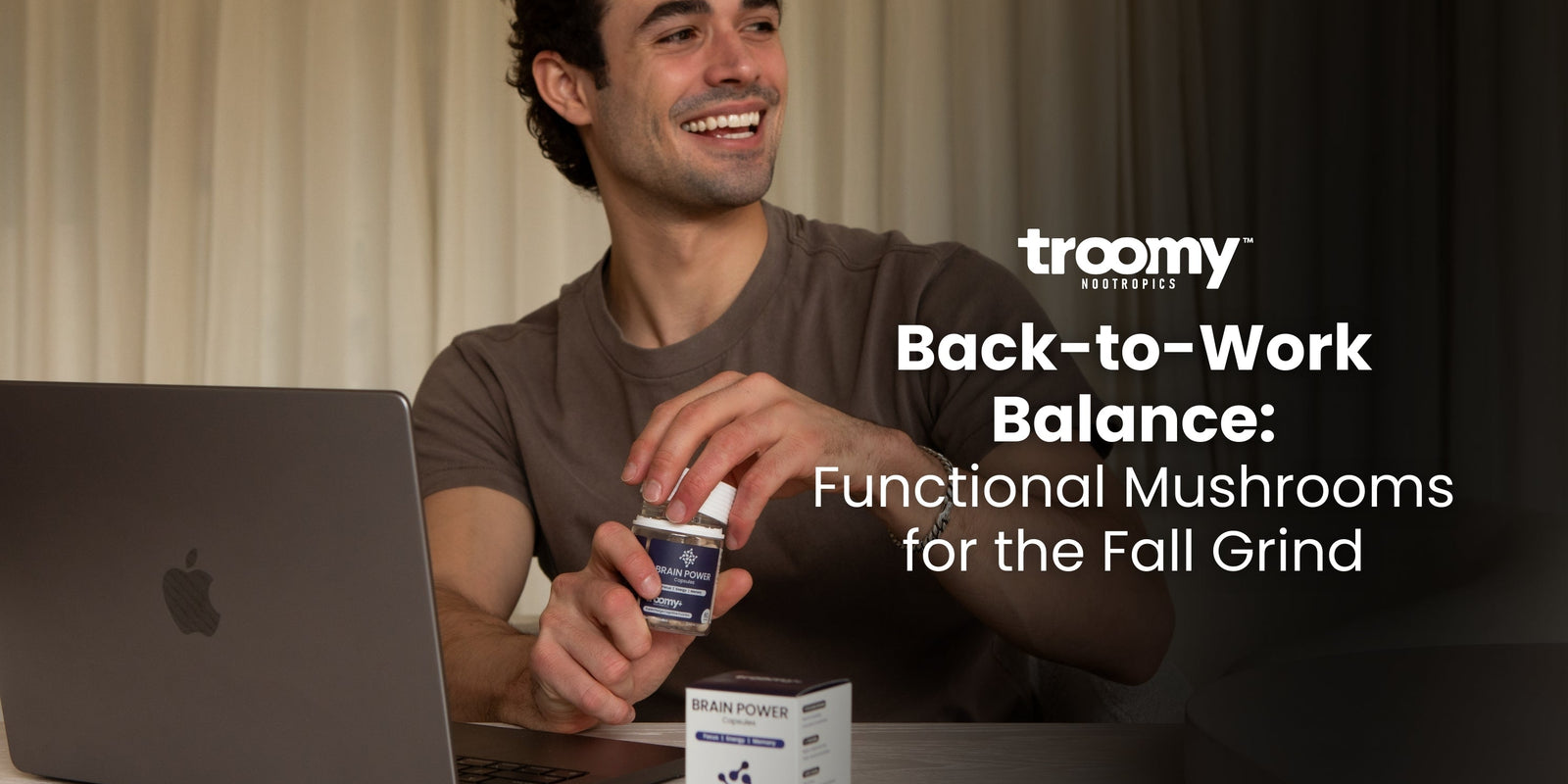 man opening brain power nootropic capsules for energy and focus at a desk with an open laptop