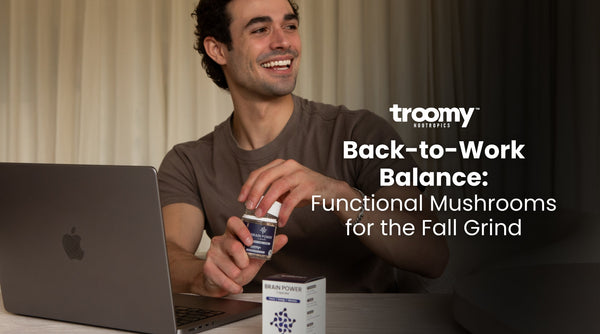 man opening brain power nootropic capsules for energy and focus at a desk with an open laptop