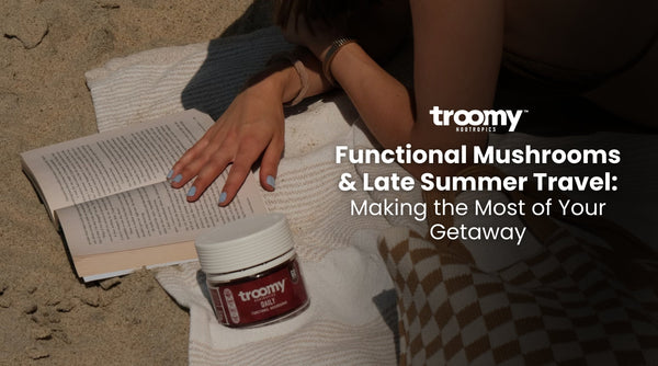 woman reading a book on the beach with functional mushroom gummies