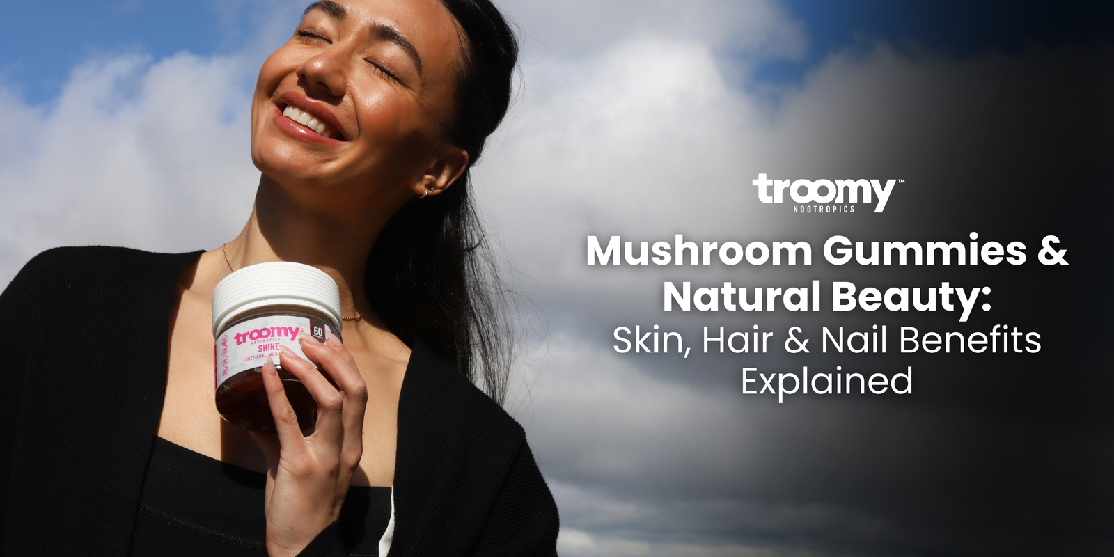 woman holding collagen gummies with smooth shiny skin