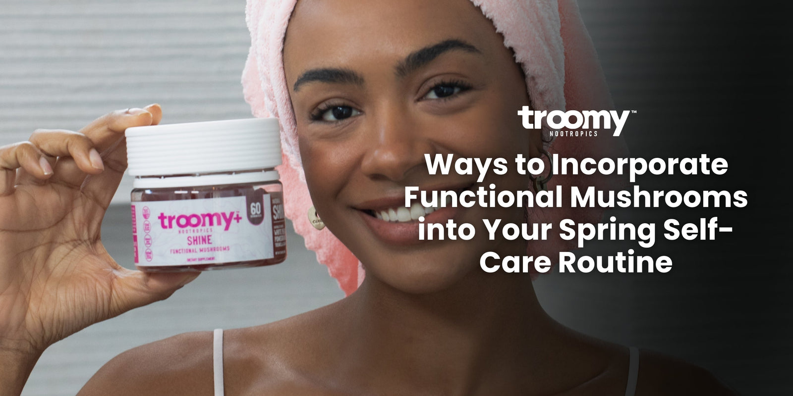 woman taking collagen in a pink bath towel