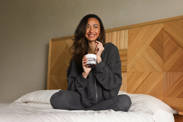 Sleep - Reishi and Melatonin - Black Raspberry - Sleep Support - Woman in Pajamas Holding Gummy - Troomy Nootropics in Whittier, CA