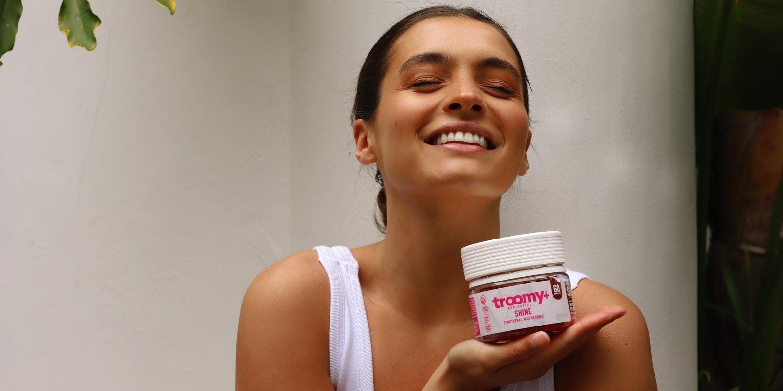 Shine - Tremella and Biotin - White Peach Pomegranate - Beauty Support - Woman Holding Jar - Troomy Nootropics in Whittier, CA